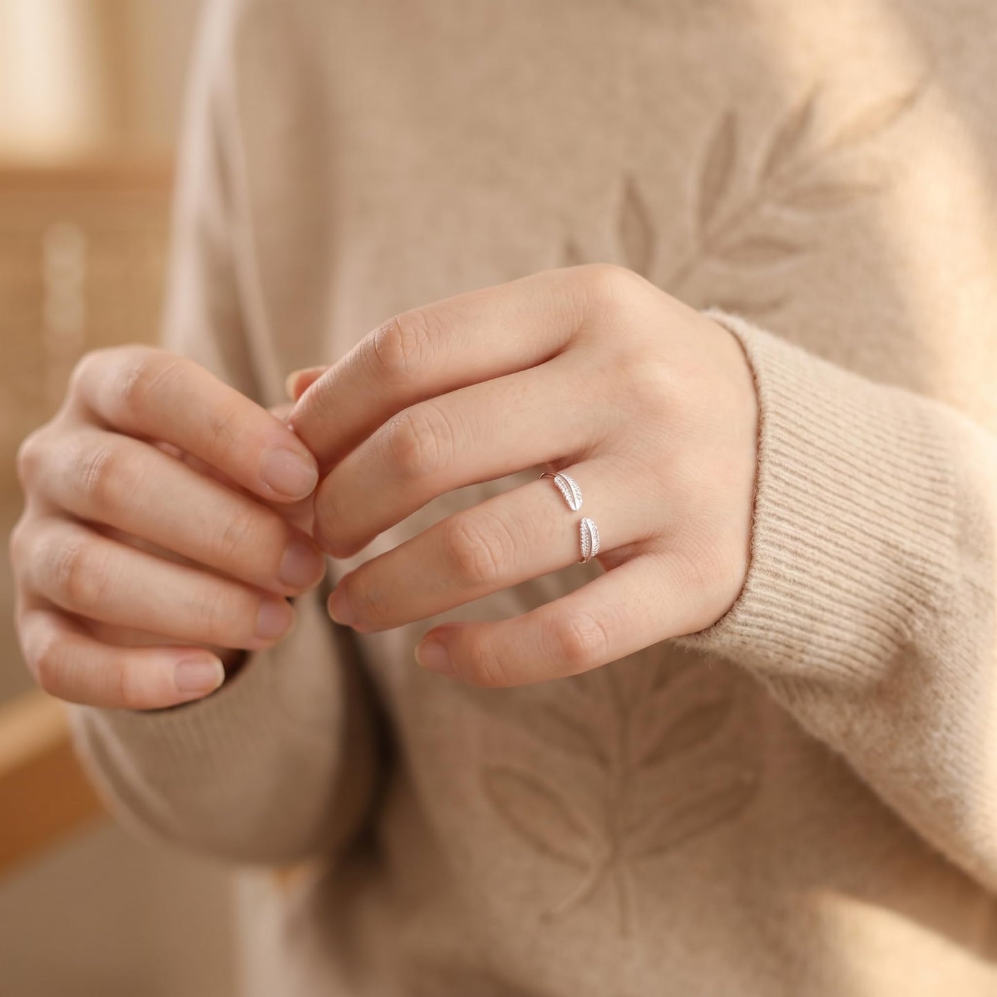 Open band silver ring with double feather wing engravings on two fingers