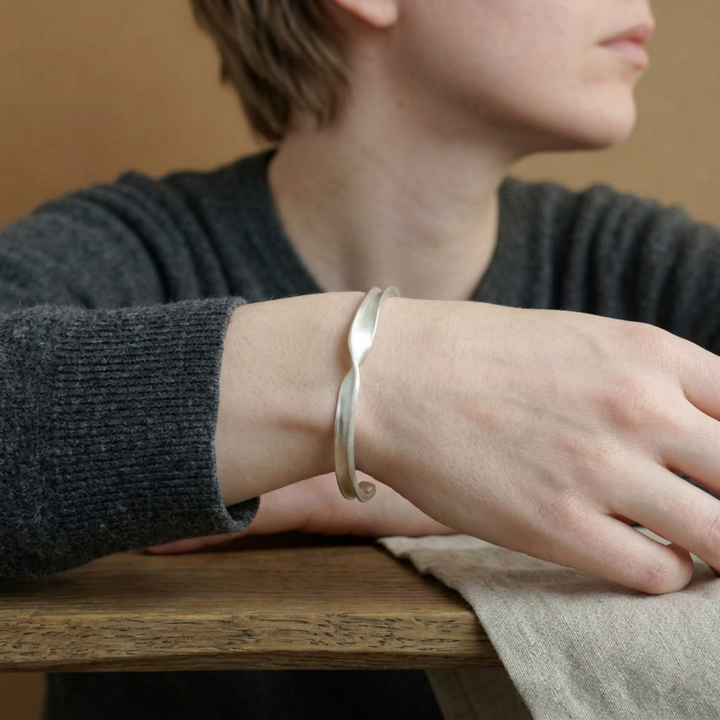 Matte Twist Rope Cuff bracelet worn on wrist, silver-toned twisted cuff