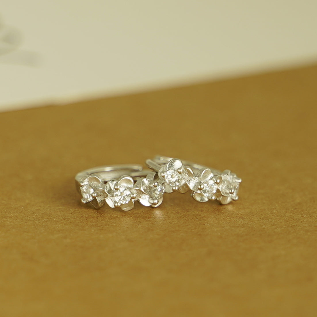 Rhodium on Sterling Silver Triple Camellia Blossom CZ Huggie Hoop Earrings - sugarkittenlondon