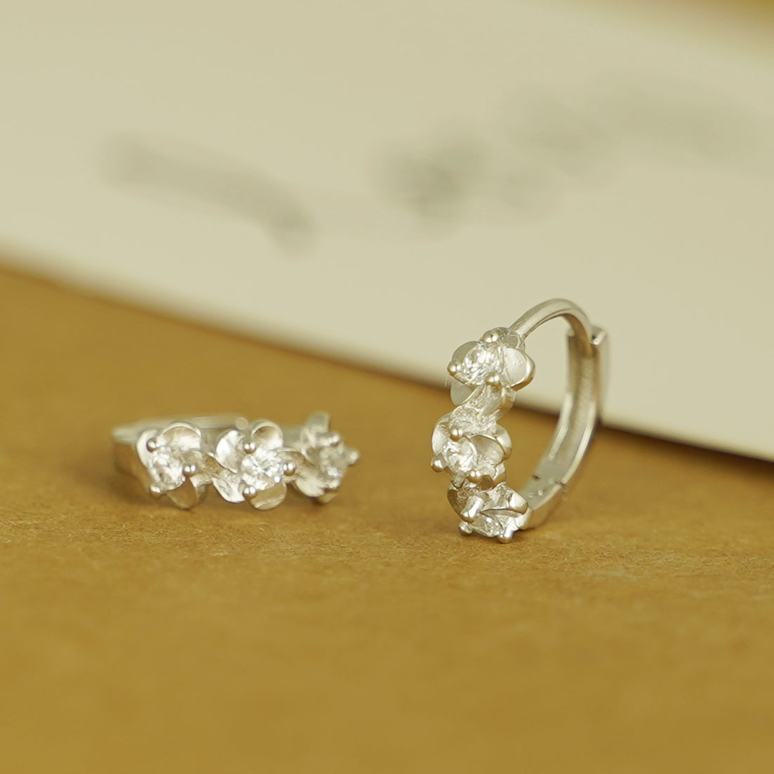 Rhodium on Sterling Silver Triple Camellia Blossom CZ Huggie Hoop Earrings - sugarkittenlondon