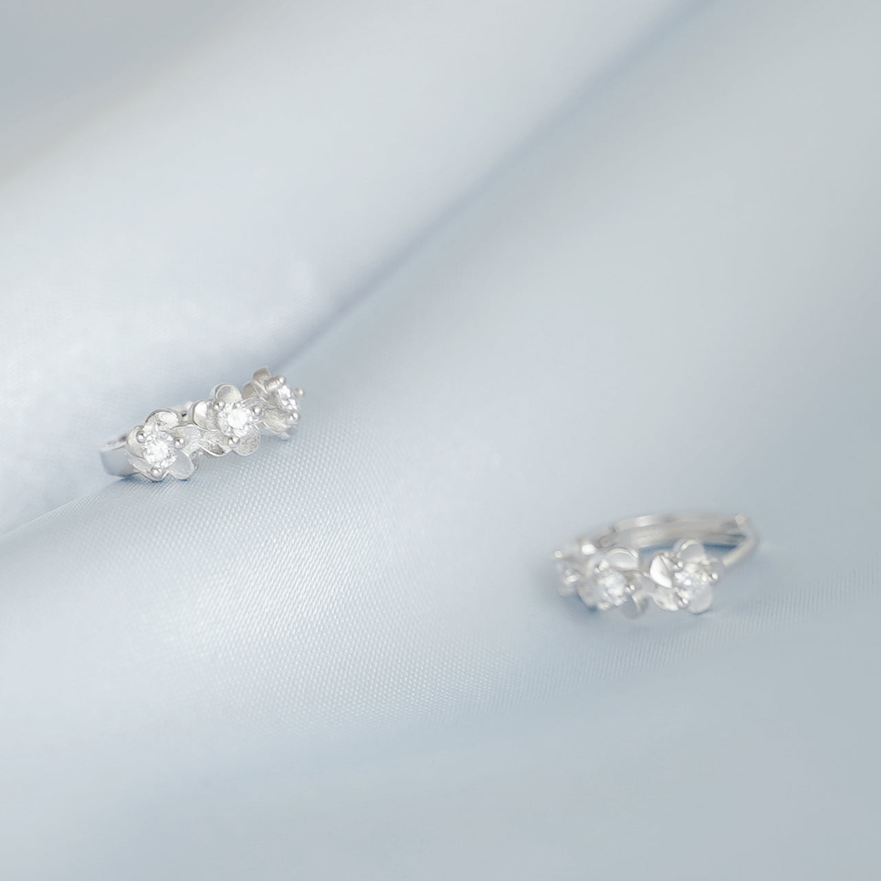 Rhodium on Sterling Silver Triple Camellia Blossom CZ Huggie Hoop Earrings - sugarkittenlondon