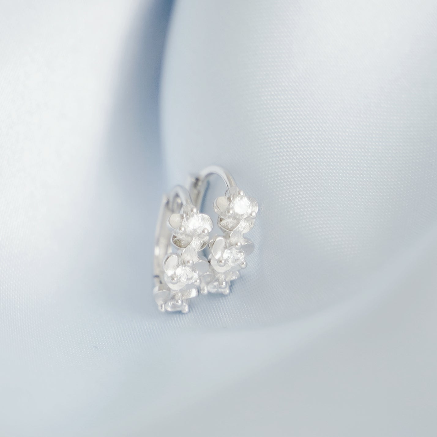 Rhodium on Sterling Silver Triple Camellia Blossom CZ Huggie Hoop Earrings - sugarkittenlondon