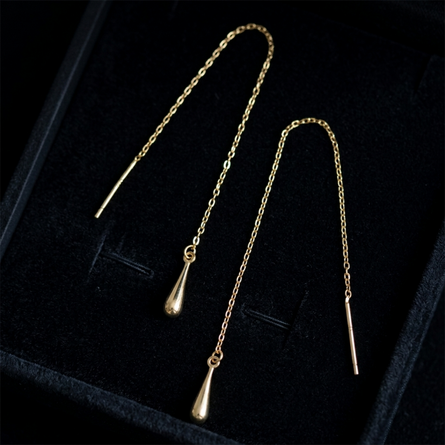 Gold-tone teardrop threader earrings with teardrop drops and long chain in box
