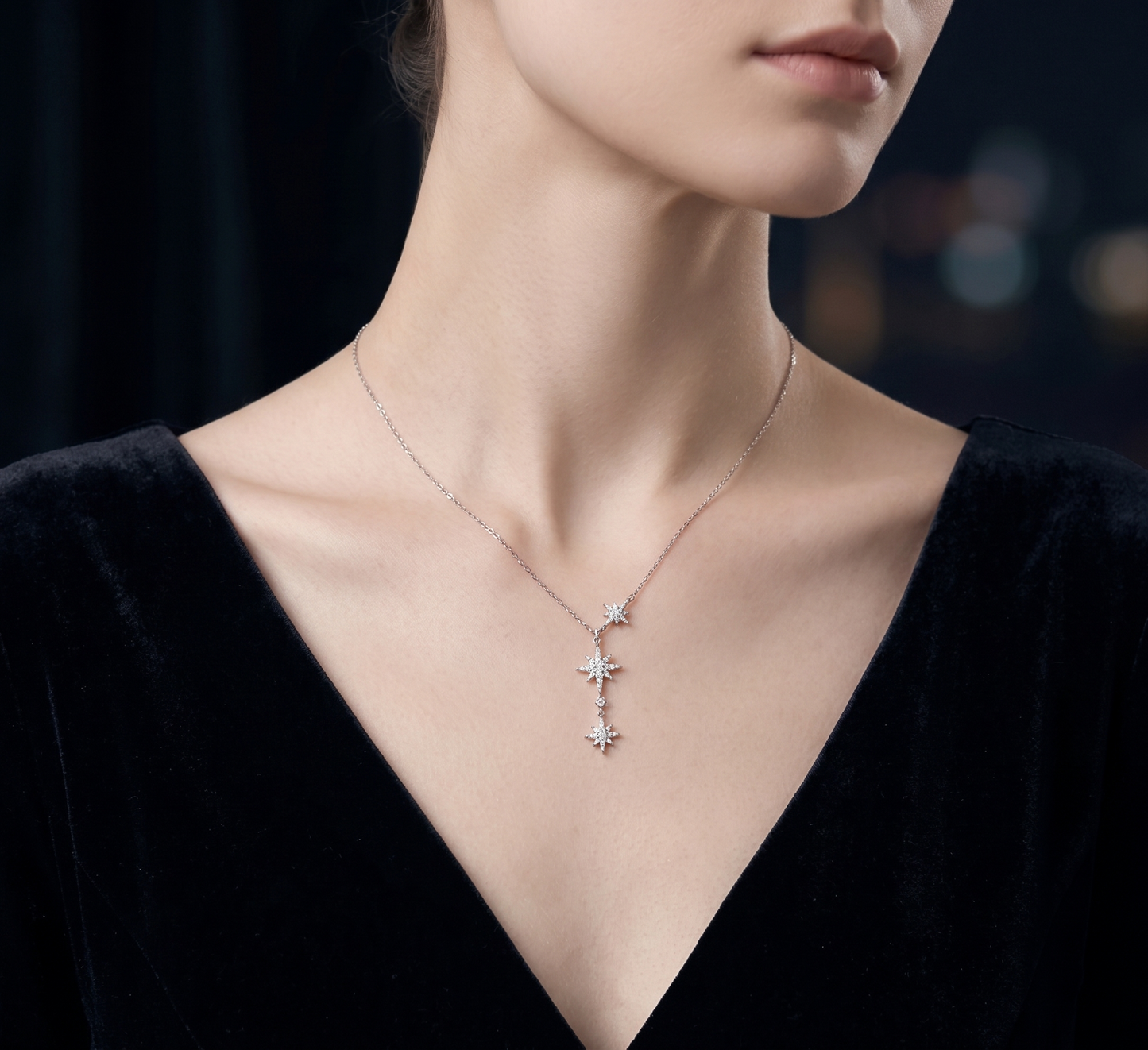 CZ Sunburst Y-necklace worn with three silver star charms on a Y-shaped chain