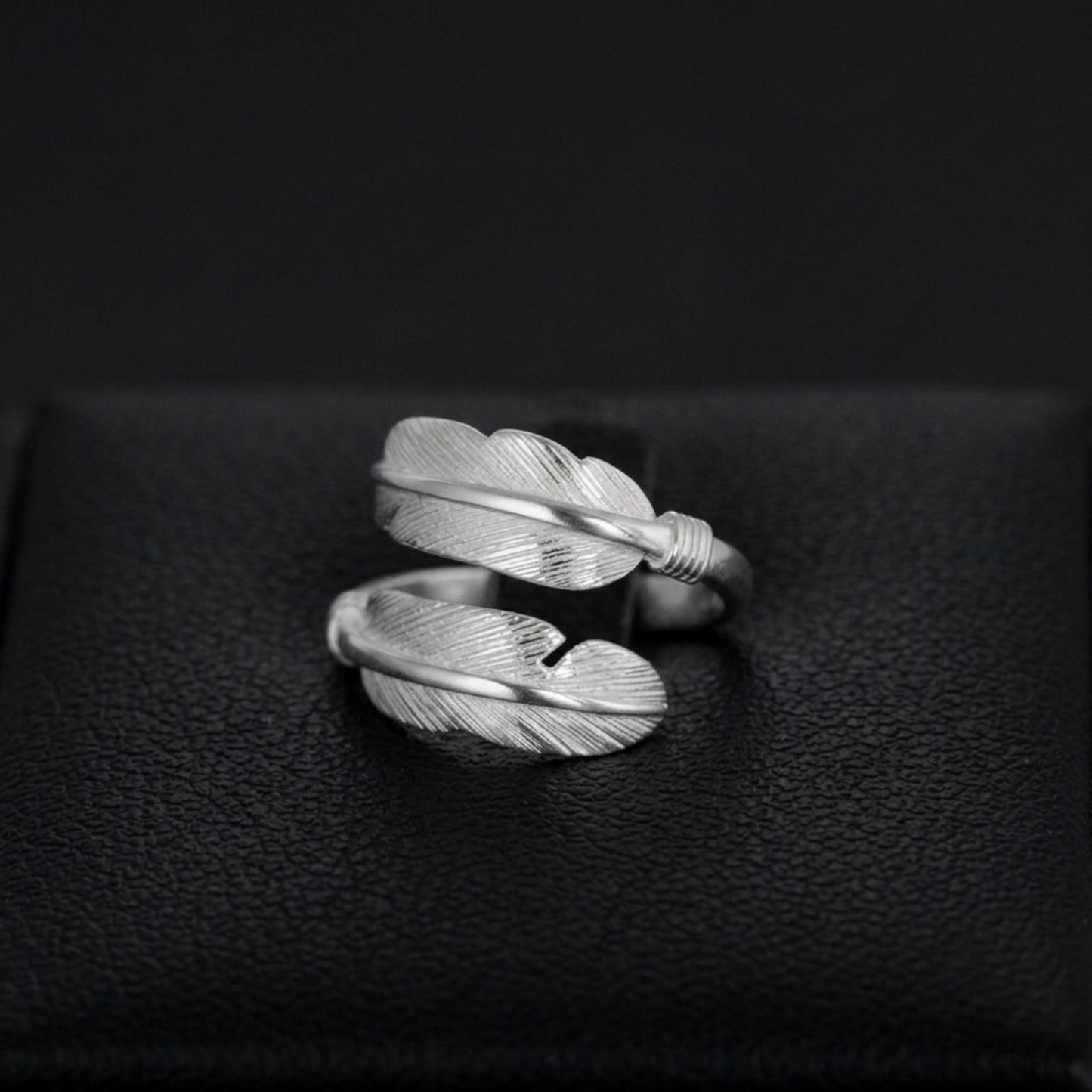 Double feather open band ring with twisted wrap, silver tone