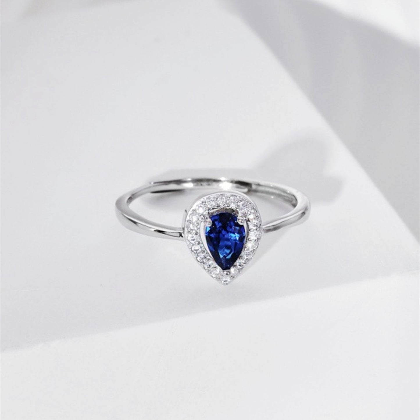 Rhodium on Sterling Silver Teardrop Cut Blue Sapphire Paved CZ Halo Sizable Ring - sugarkittenlondon