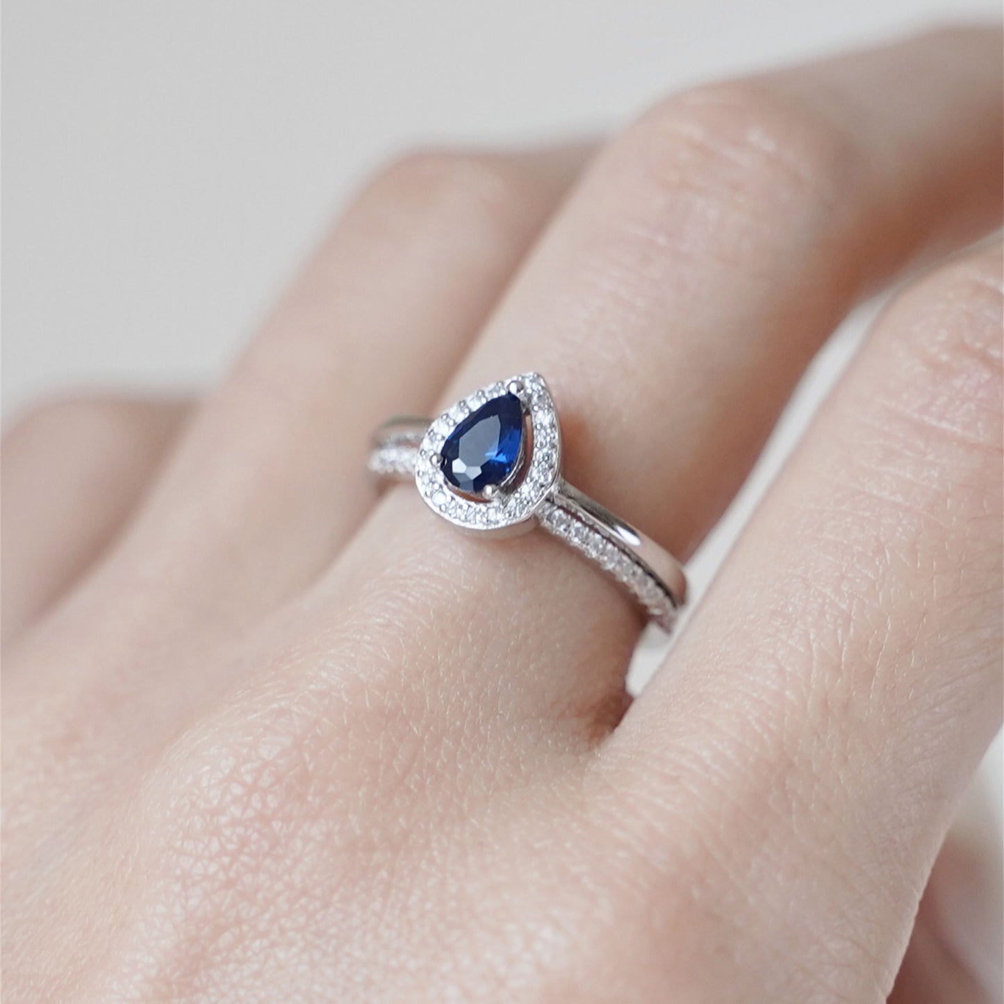 Rhodium on Sterling Silver Teardrop Cut Blue Sapphire Paved CZ Halo Sizable Ring - sugarkittenlondon