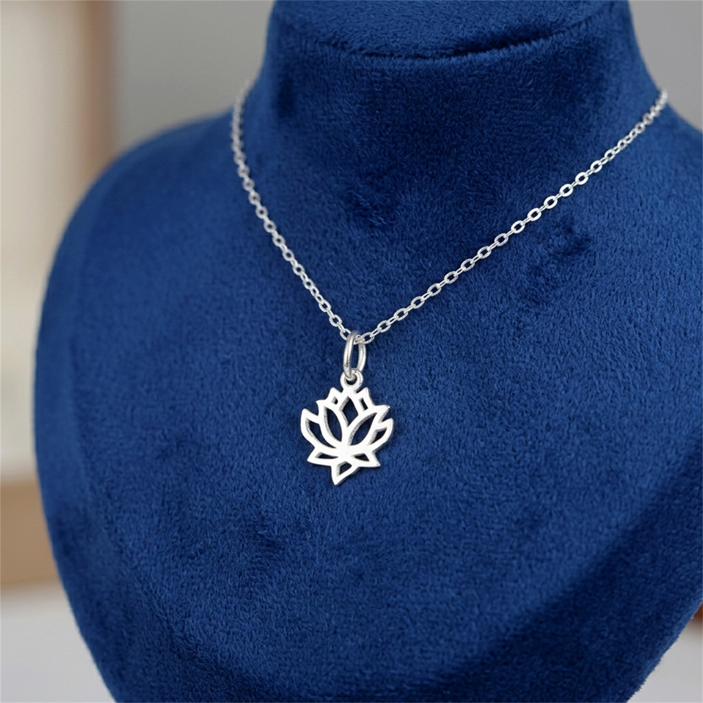 Silver chain necklace with centered filigree lotus charm pendant