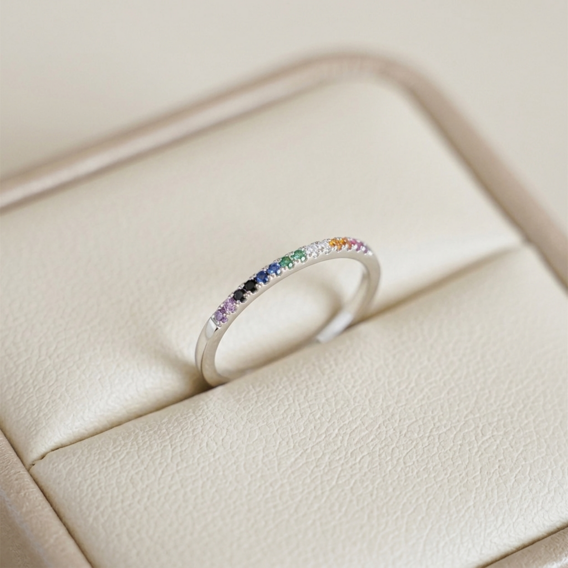 Half-eternity rainbow ring with multicolor stones on slim silver band, top view