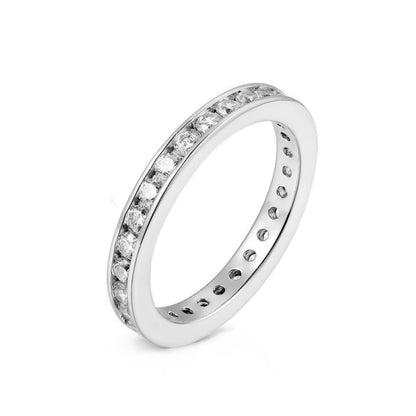 Channel-set eternity ring with clear round stones on a silver band, side view
