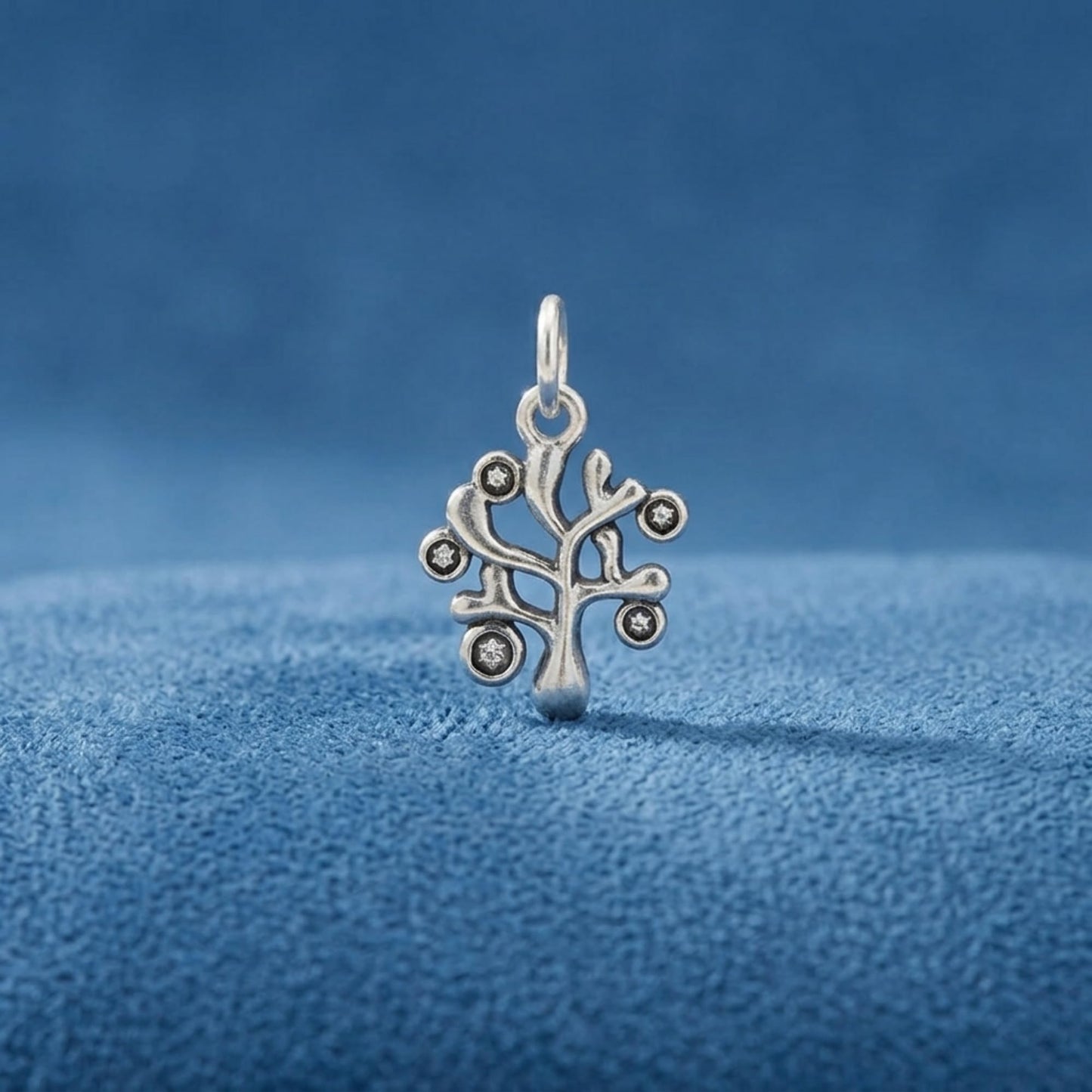 Silver Tree of Life charm pendant with circular stone accents and top hanging loop