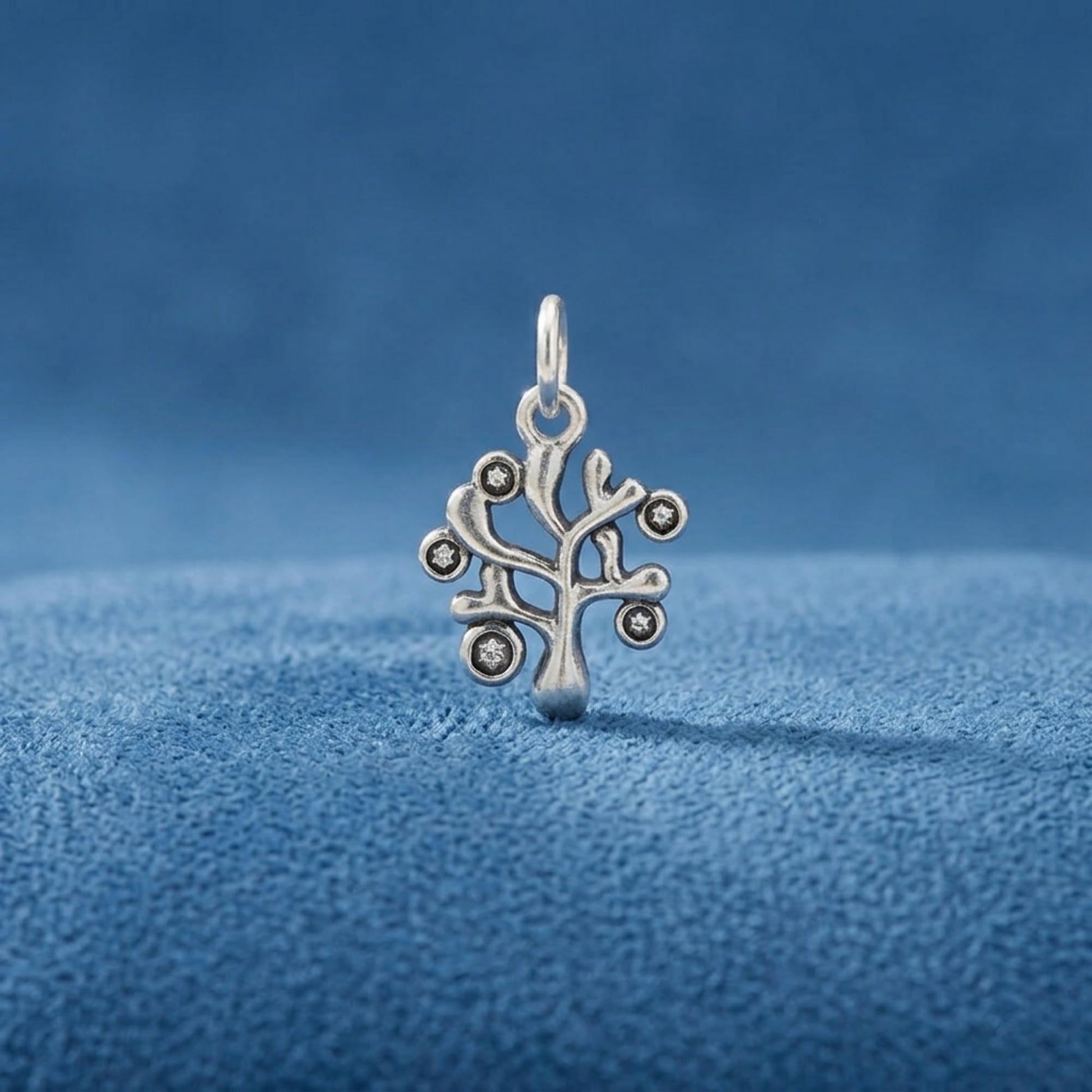 Silver Tree of Life charm pendant with circular stone accents and top hanging loop