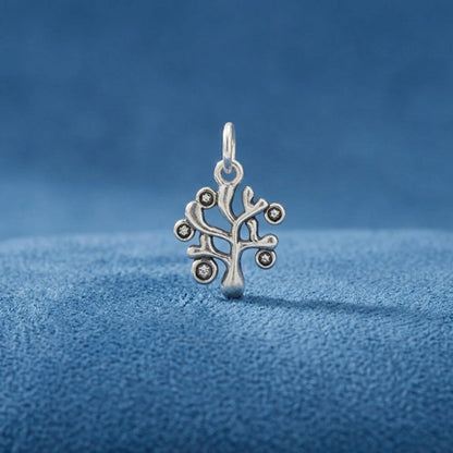 Silver Tree of Life charm pendant with circular stone accents and top hanging loop