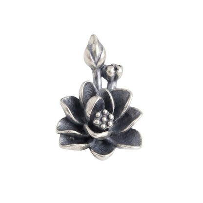 Oxidized lotus flower charm with textured petals and small bead details