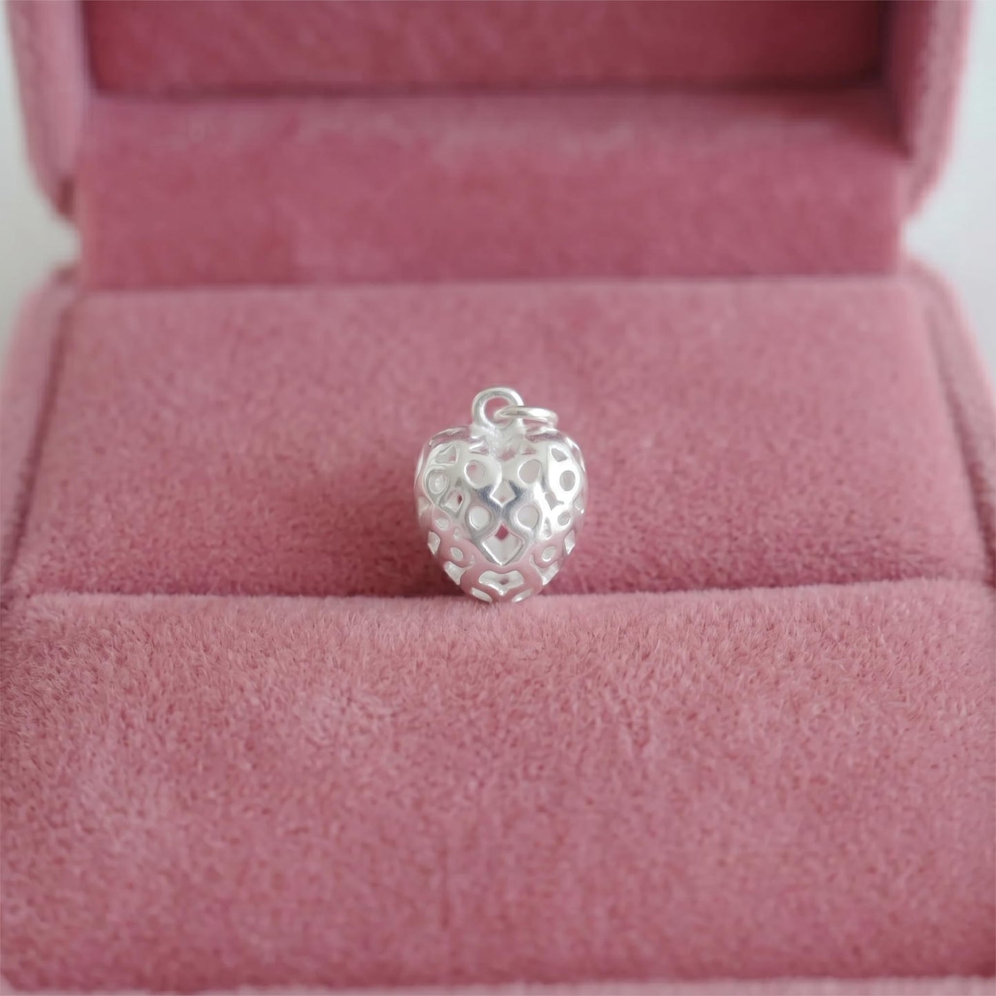 Heart pendant with polished cut-out details, in a jewelry box