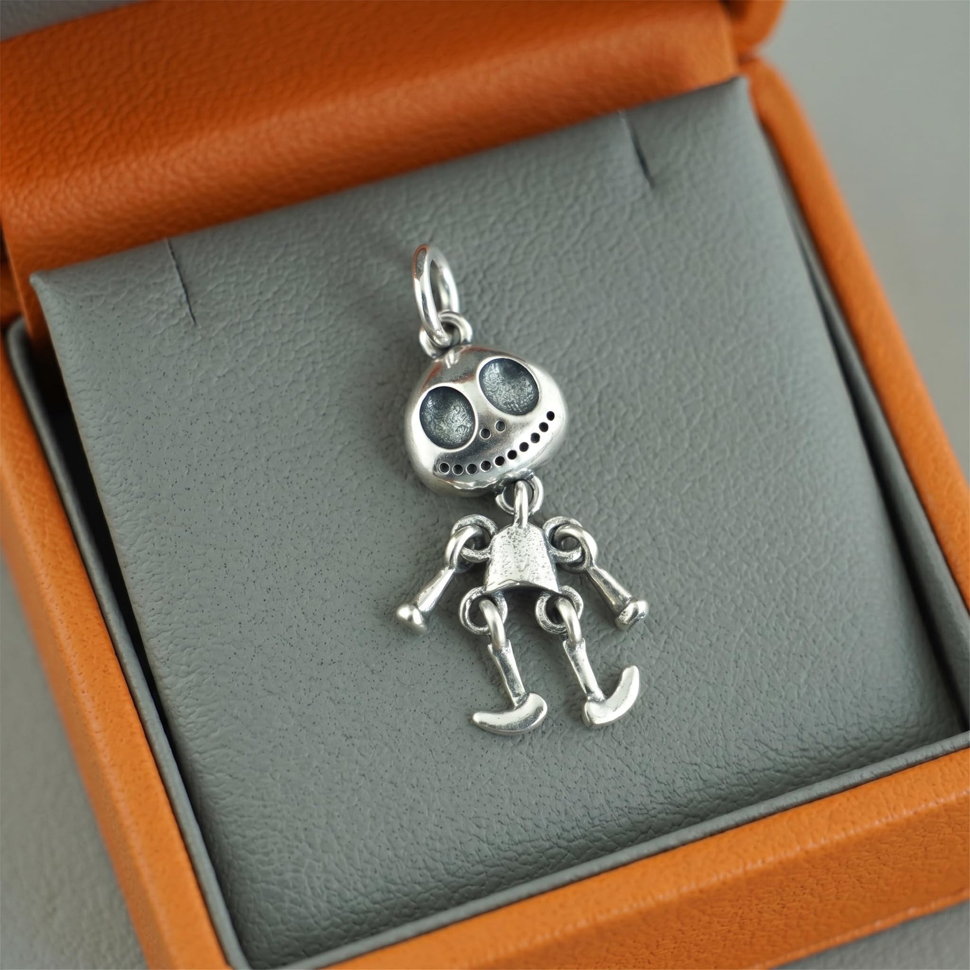 Movable ghost pendant with oval head and small teeth, silver-tone articulated parts