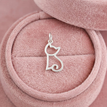 Silver-tone hollow kitten charm on pink velvet cord, with loop bail at top.