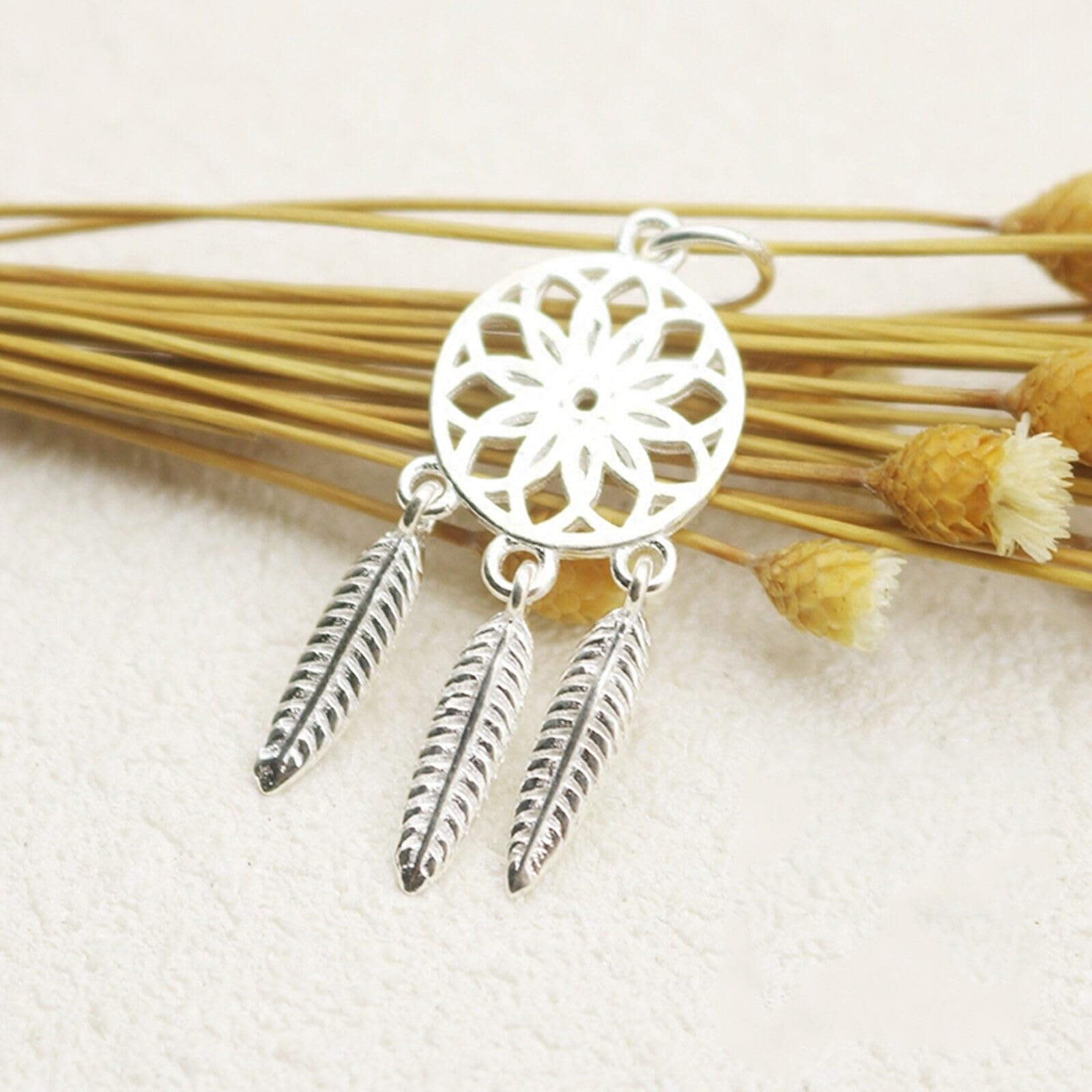 Dream Catcher Charm: silver-tone dreamcatcher medallion with three textured feather drops