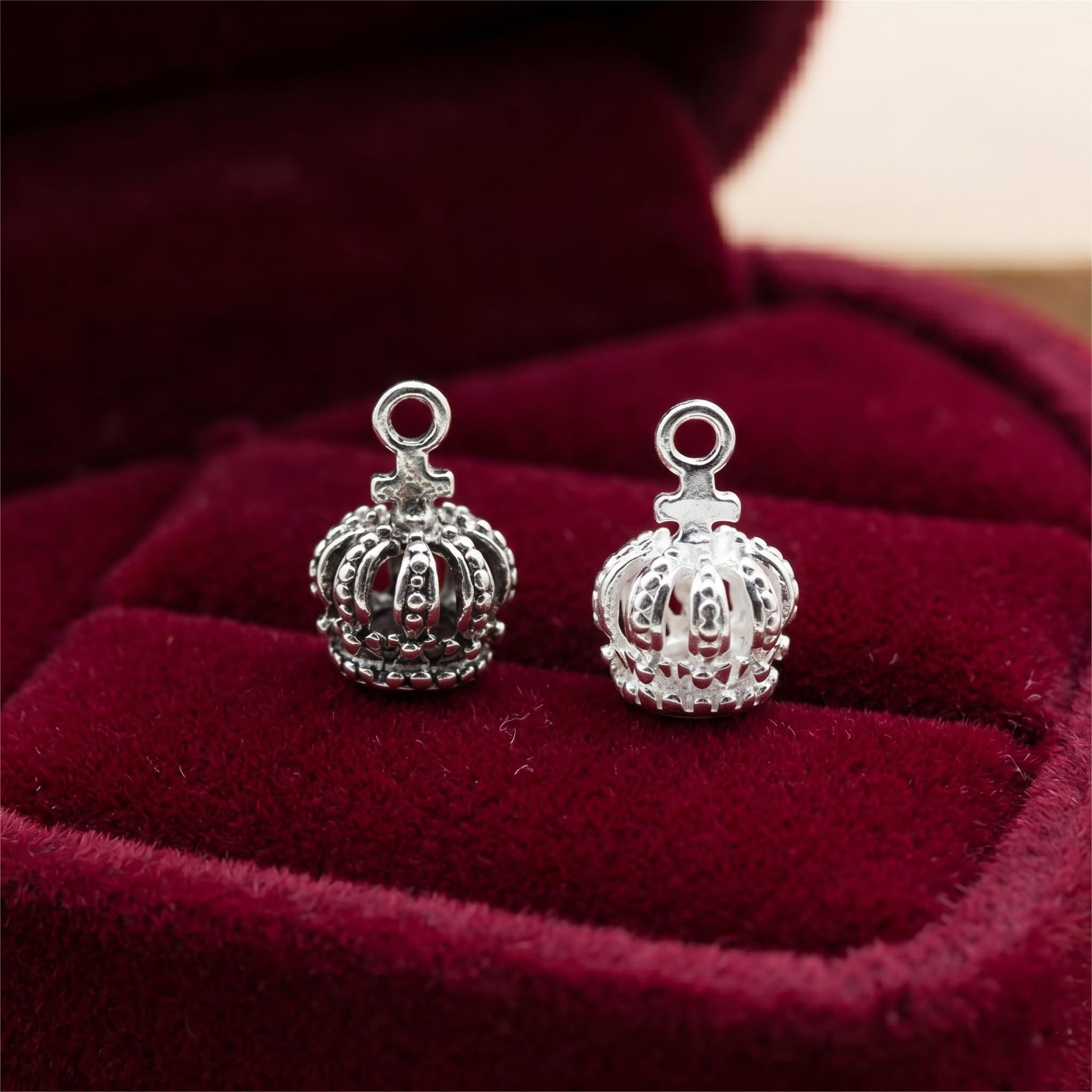 Two mini crown charms with ring loops, silver-tone with textured crown edges