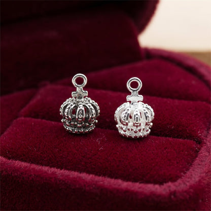 Two mini crown charms with ring loops, silver-tone with textured crown edges