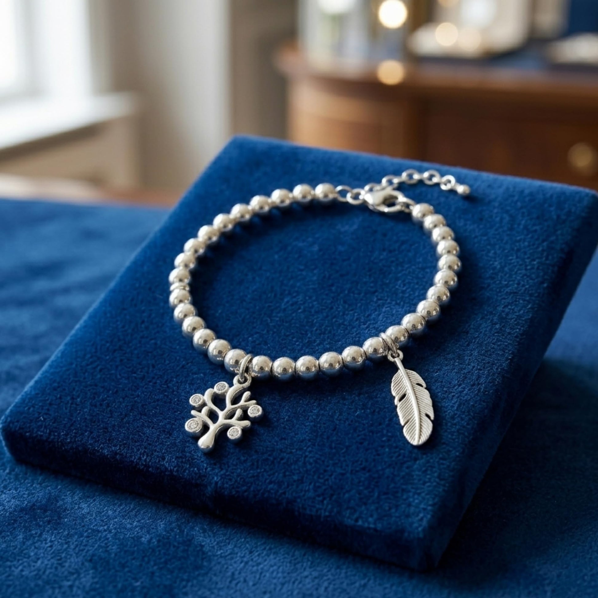 Tree of Life charm on a silver beaded bracelet with a leaf charm