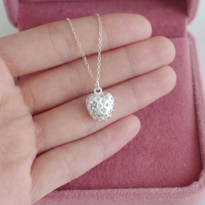 Heart pendant on a silver chain, cut-out heart charm shown in box