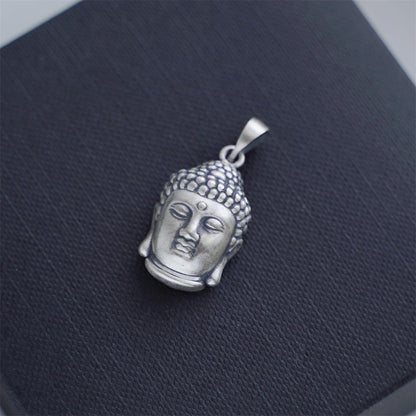 Buddha head pendant, angled view with textured hair, silver-tone