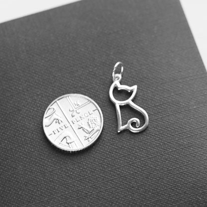 Silver-tone hollow kitten charm pendant, angled view, small loop bail on top.
