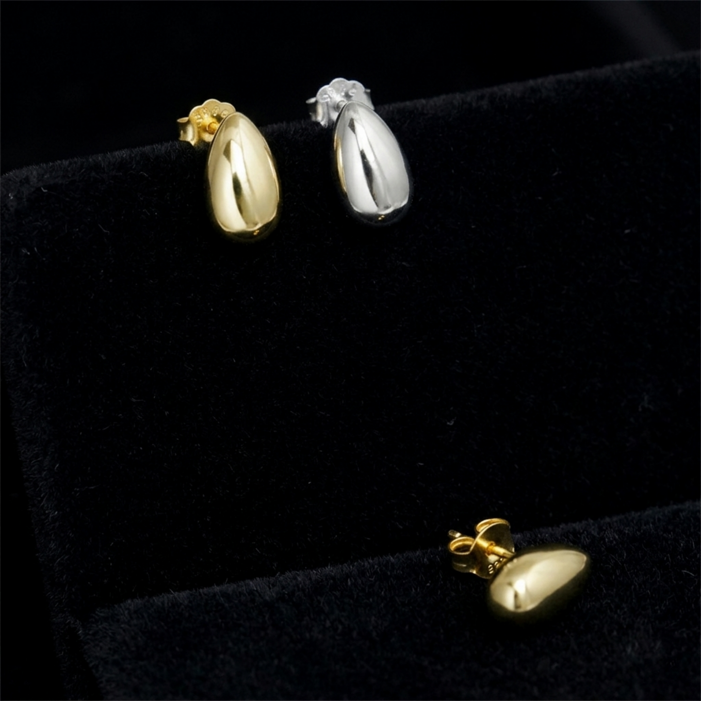 Gold and rhodium teardrop stud earrings with smooth oval drop fronts