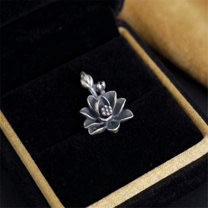Oxidized lotus flower charm with dotted center and raised petal texture