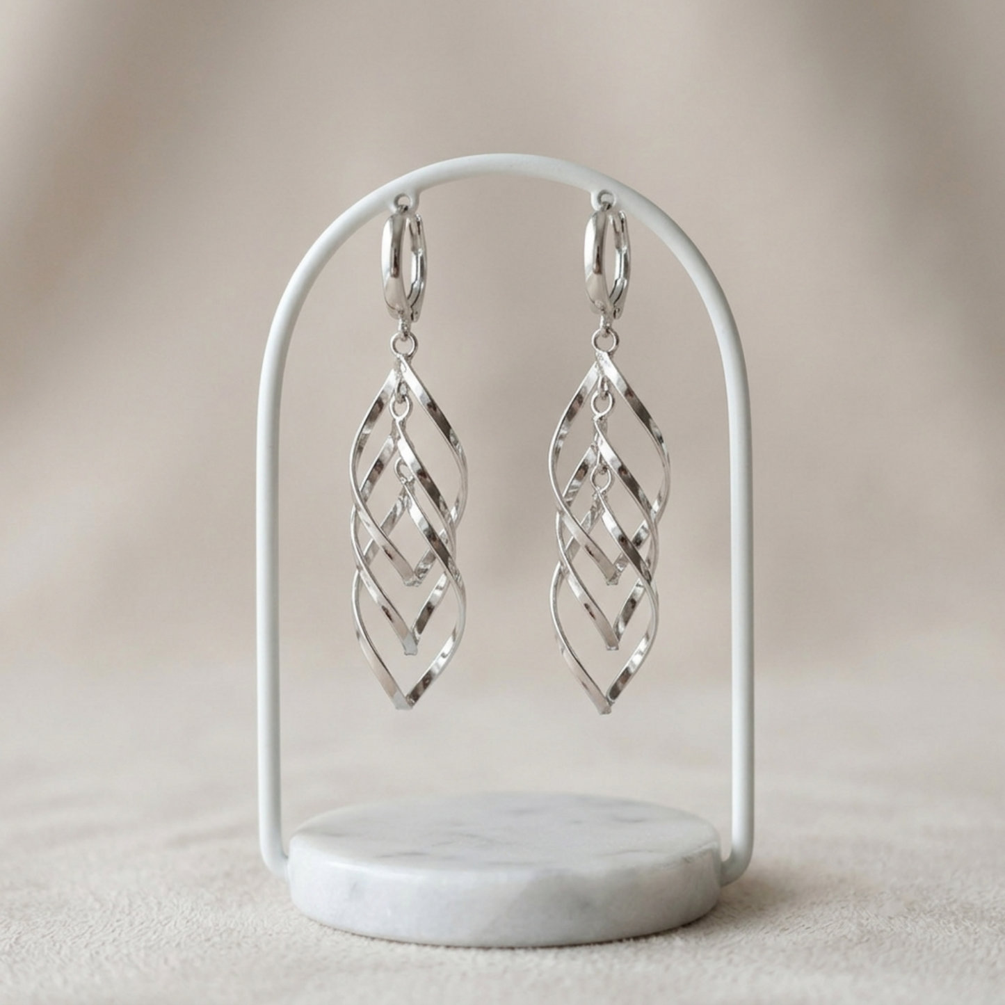 Pair of silver-tone long dangling hoop earrings with geometric lattice drops