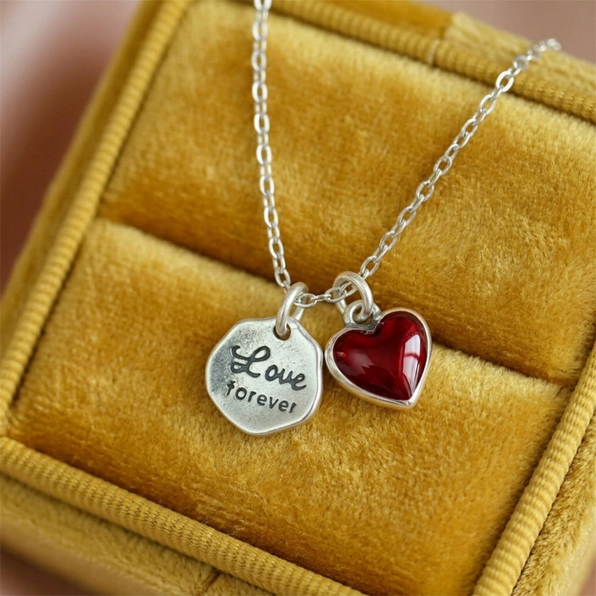 “Love forever” hexagon charm with red heart charm on necklace