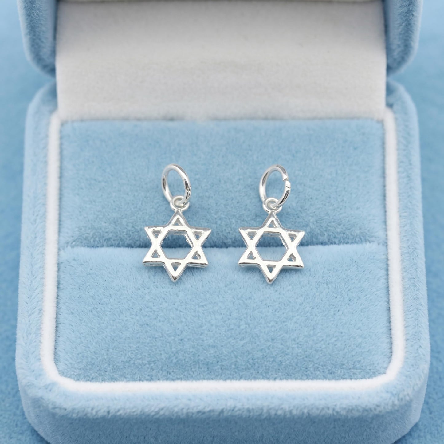Two Star of David hollow charms with small loops, silver-tone