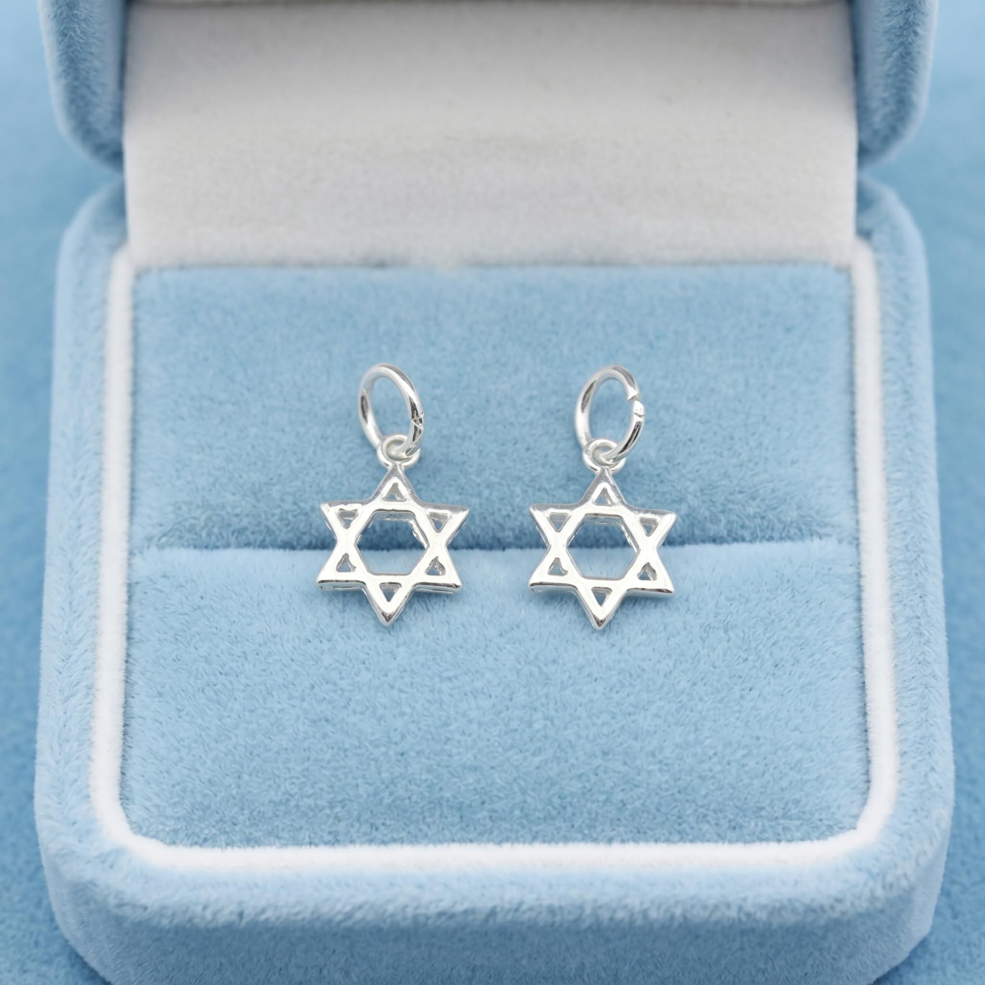 Two Star of David hollow charms with small loops, silver-tone