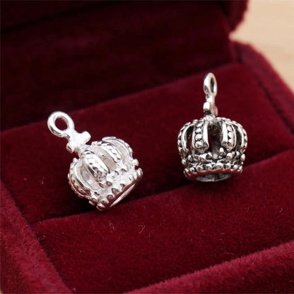 Mini crown charm pair on velvet, silver-tone crowns with raised details