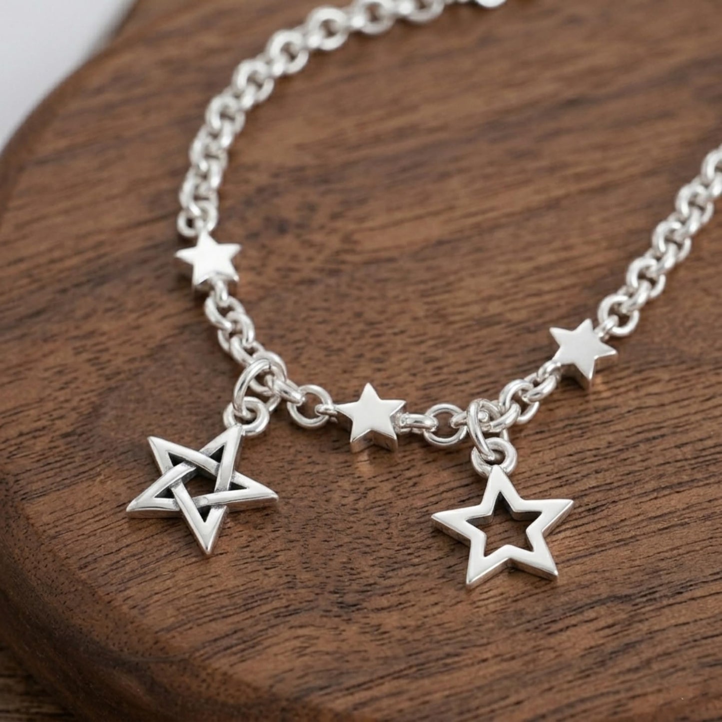 Lucky star charm on chain: three linked star pendants with ring loops