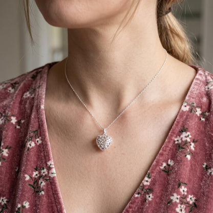 Heart pendant necklace with polished cut-out heart charm hanging on chain
