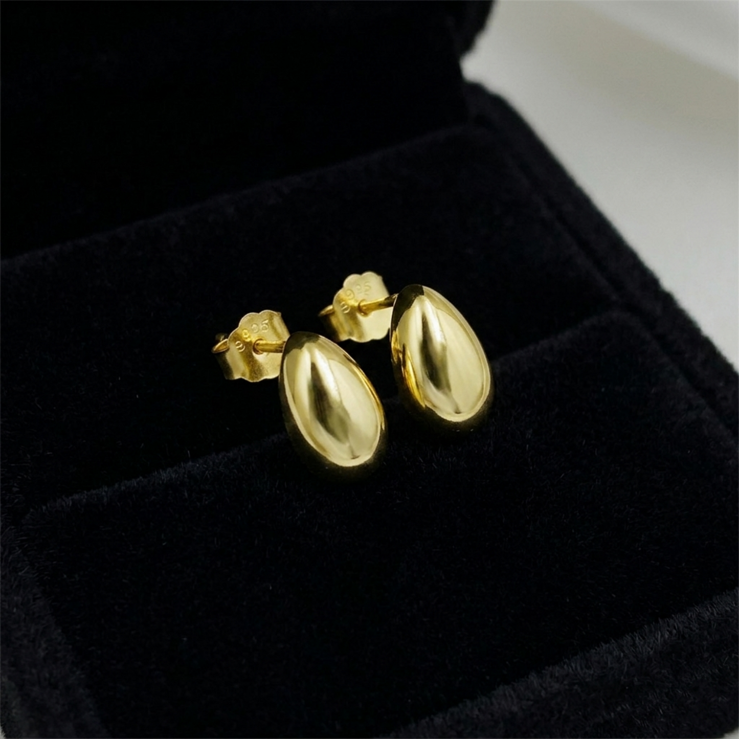 14K gold teardrop stud earrings with shiny oval drop faces