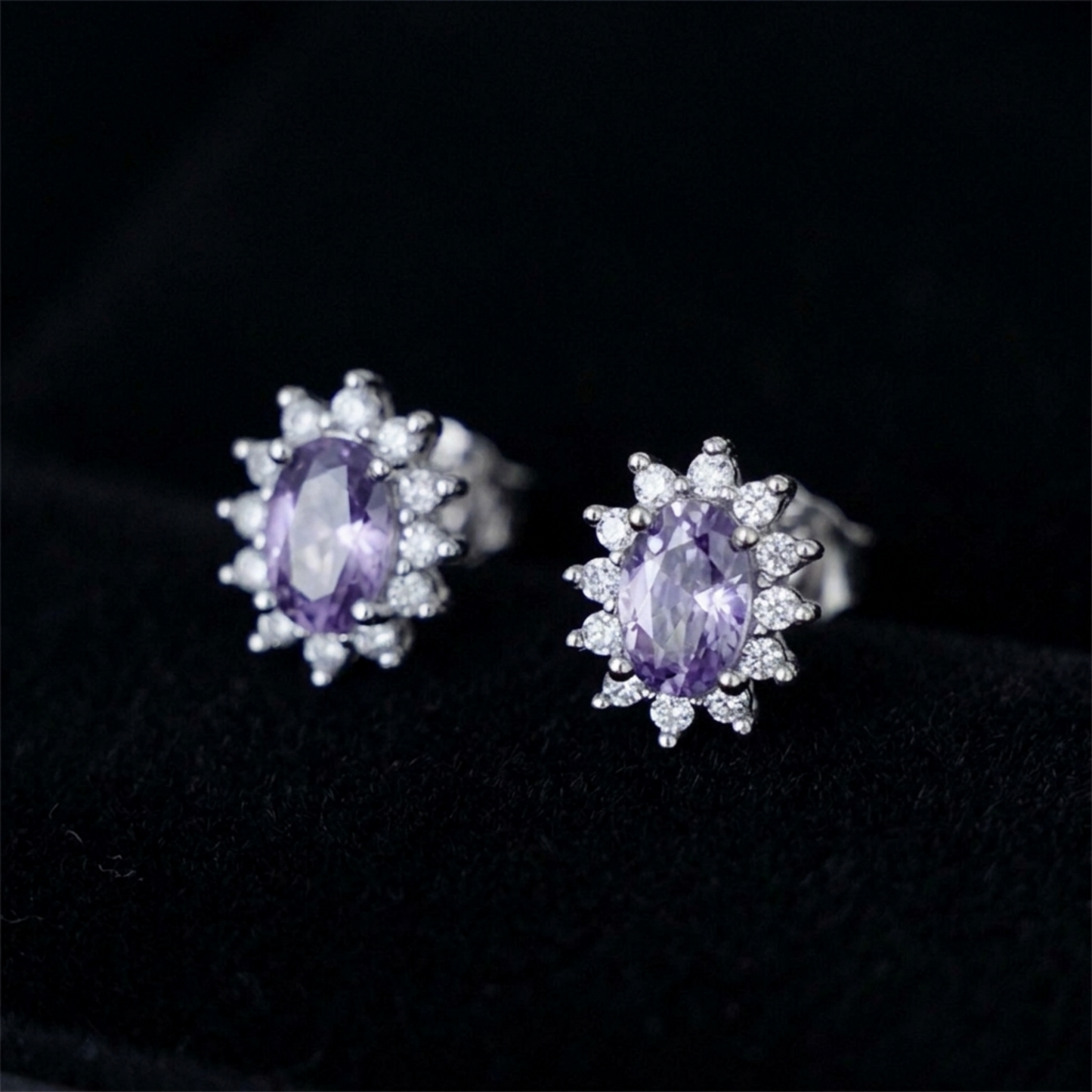 Close-up: oval amethyst cluster stud earrings with crystal halo, silver-tone setting