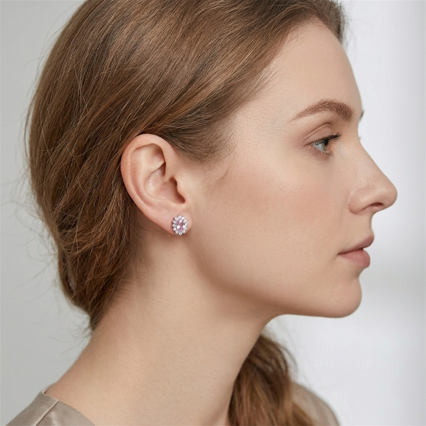 Pink oval gemstone cluster earrings worn on ear