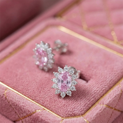Pink oval gemstone cluster earrings on jewelry box