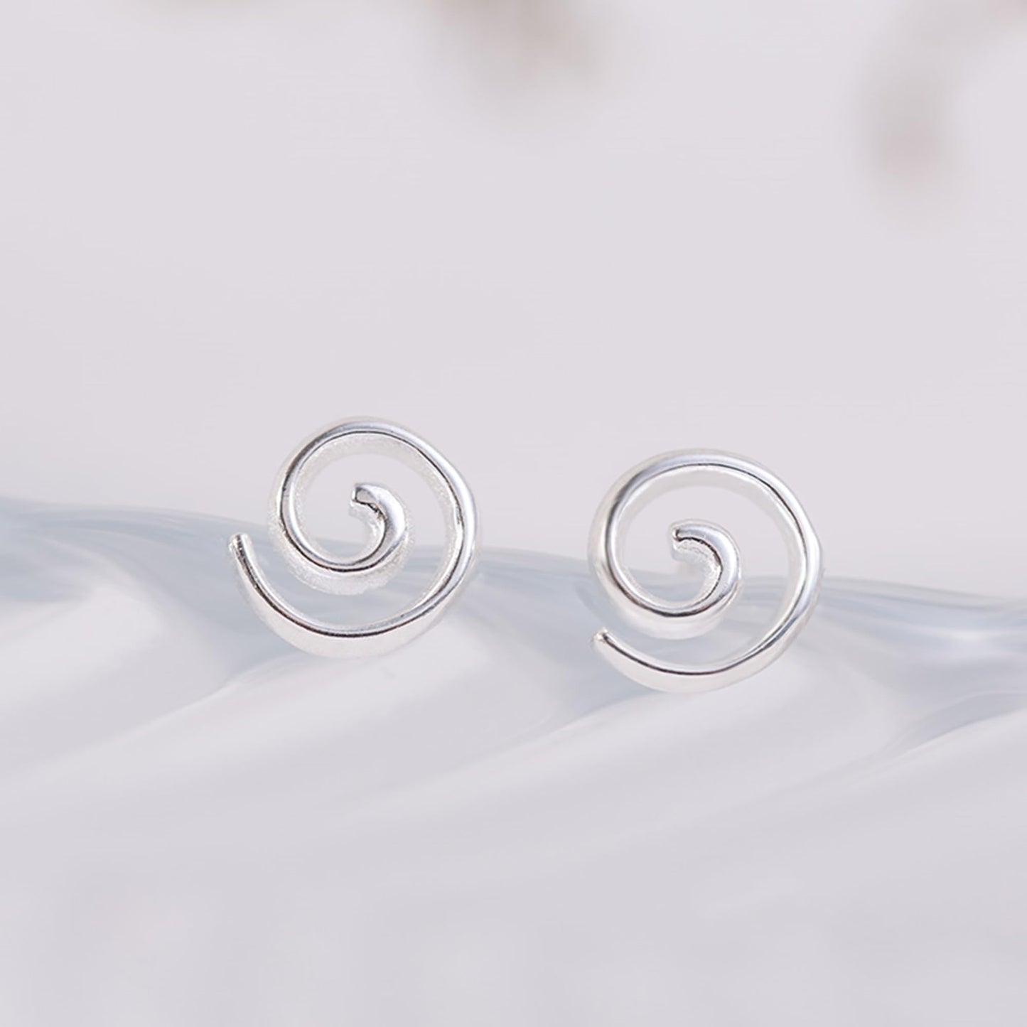 Silver spiral swirl stud earrings, round swirl fronts with straight post backs.