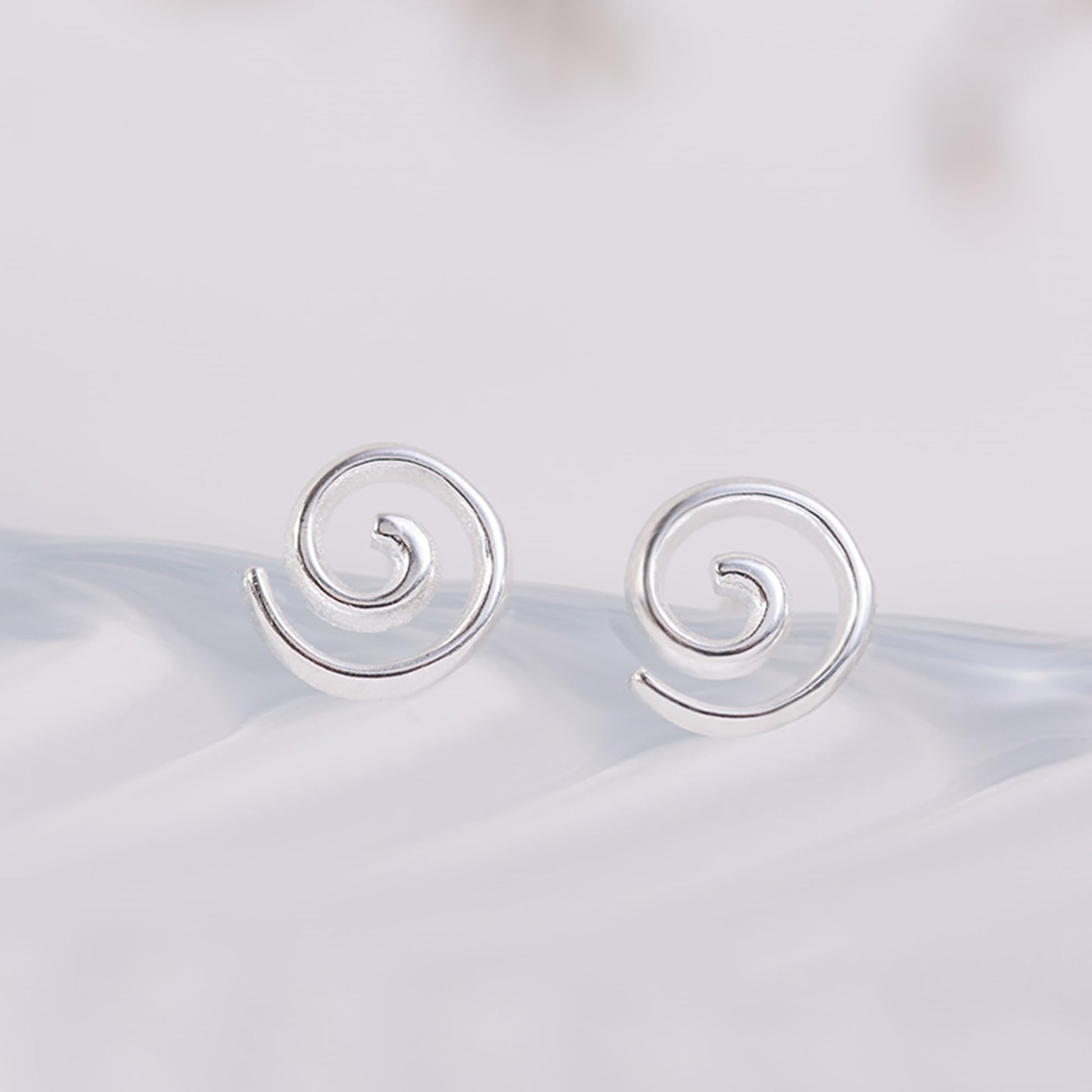 Silver spiral swirl stud earrings, round swirl fronts with straight post backs.
