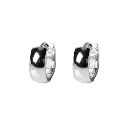 Silver-tone bold huggie hoop earrings, angled view with dark center inset