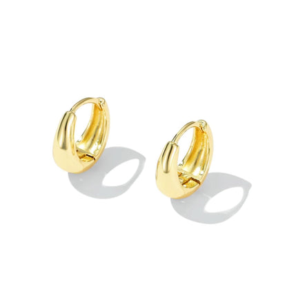 Gold teardrop hoop huggie earrings, two-piece pair with rounded open center.