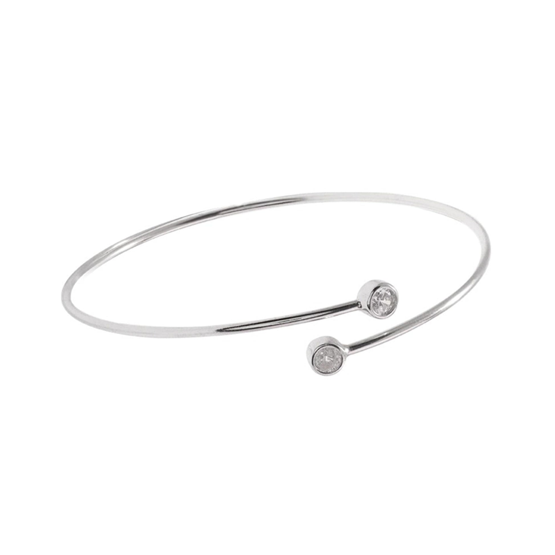 Silver-tone torque bangle with round CZ stone on front and curved bar details