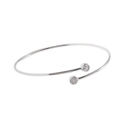Silver-tone torque bangle with round CZ stone on front and curved bar details