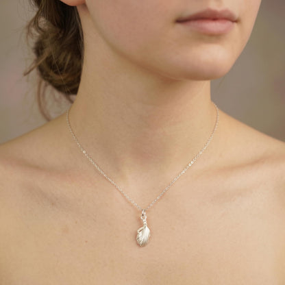 Silver necklace with a small feather wing pendant charm on a fine chain.