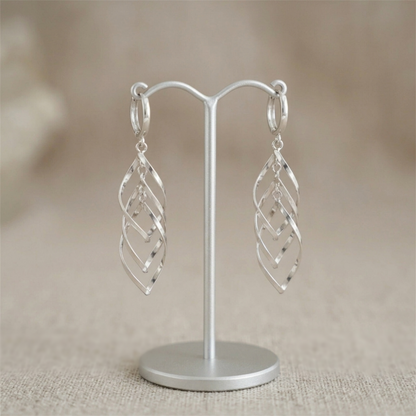 Silver-tone long hanging hoop earrings with overlapping lattice design, on stand