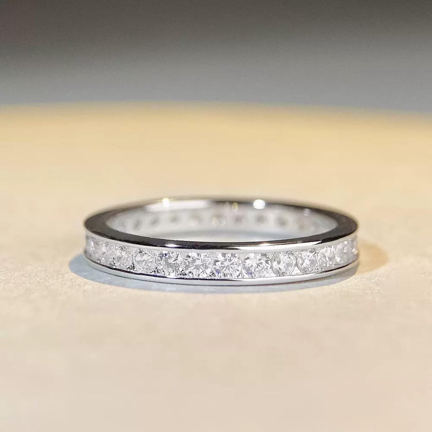 Silver eternity ring with pavé round stones across the top, low profile view
